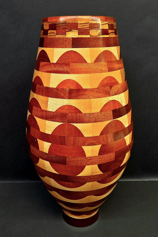 Wooden vase with geometric pattern on a black background